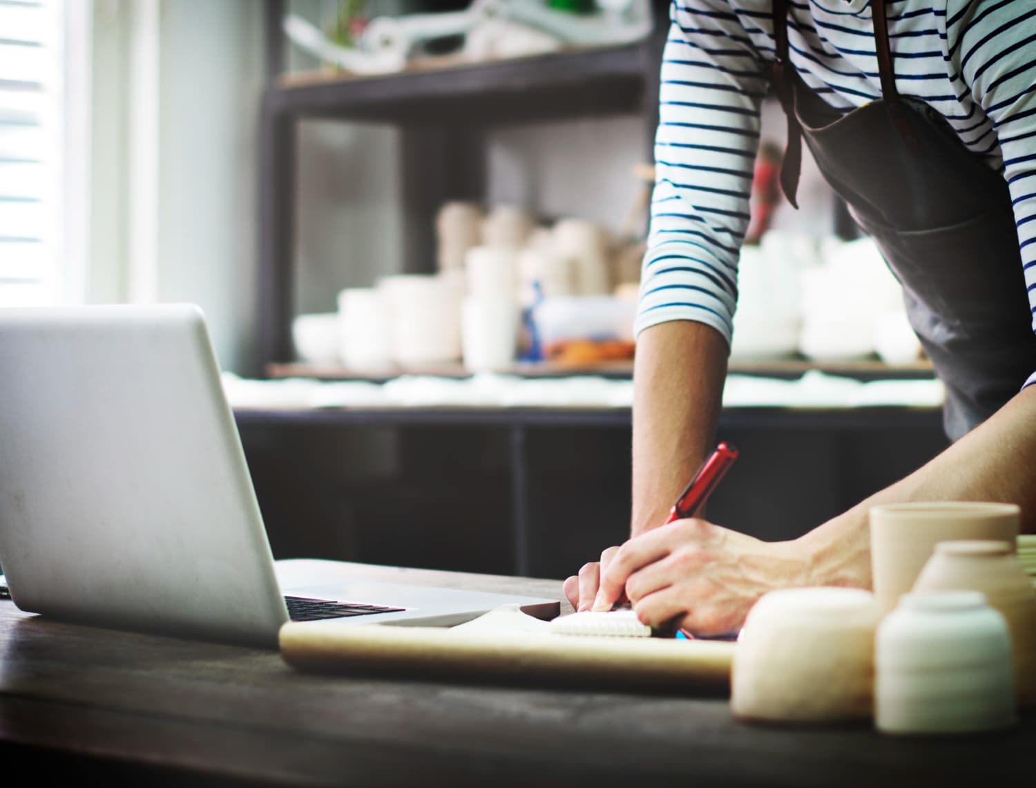 A business owner working on a laptop displaying a modern website.